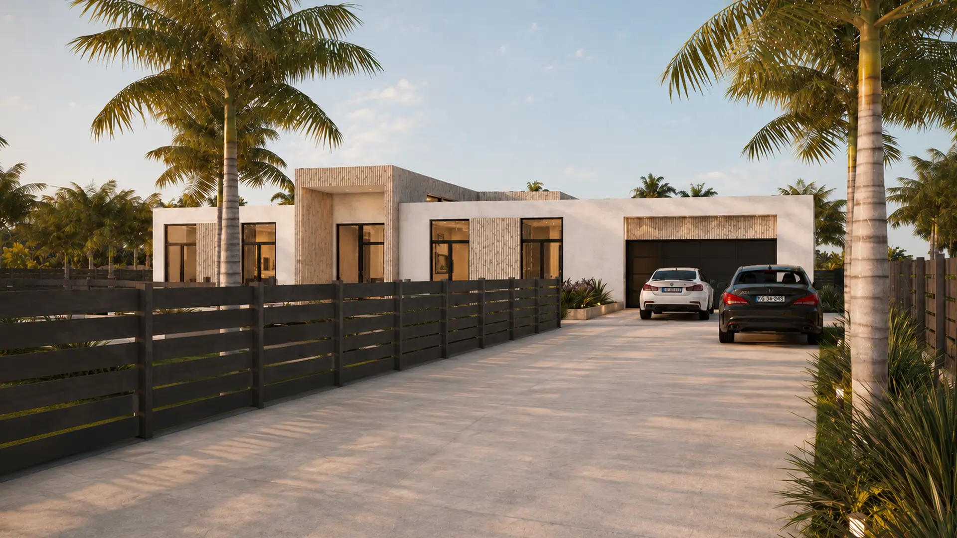 Looking up the paver driveway toward the open garage, two cars parked, slatted fence on the left and palms overhead